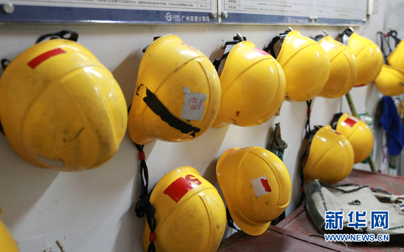 值班室,工区工作人员的"安全帽"整整齐齐挂在墙壁上.新华网 伍嘉炜摄